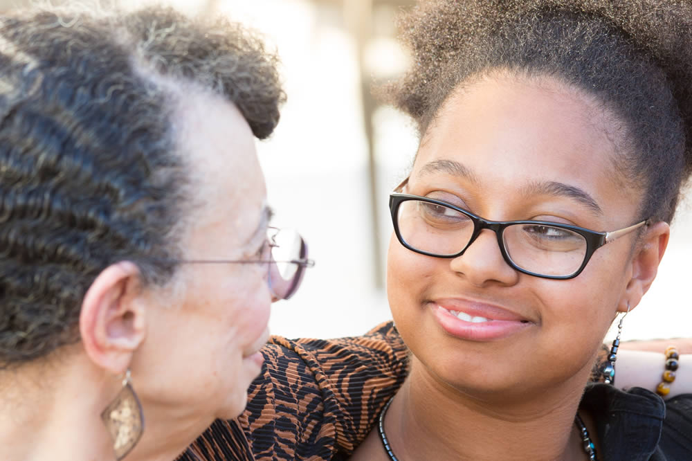 Photo of person smiling with pen and paper